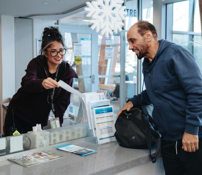 receptionist showing document to customer