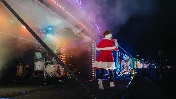 Holiday decorated train stopped with musical performance