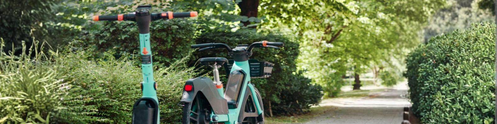 e bike and escooter parked on path