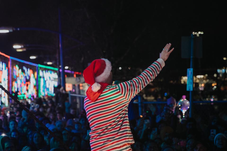performer waving to crowd from holiday train