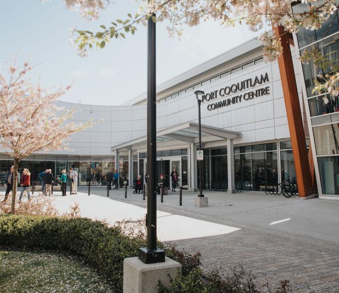 outside Port Coquitlam Community Centre with cherry blossoms in bloom