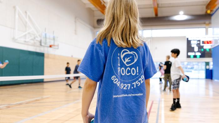 Kid in gymnasium wearing I Love PoCo Recreation shirt