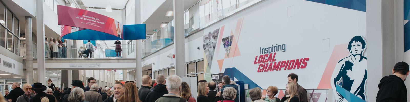 People gathering in front of Terry Fox exhibit