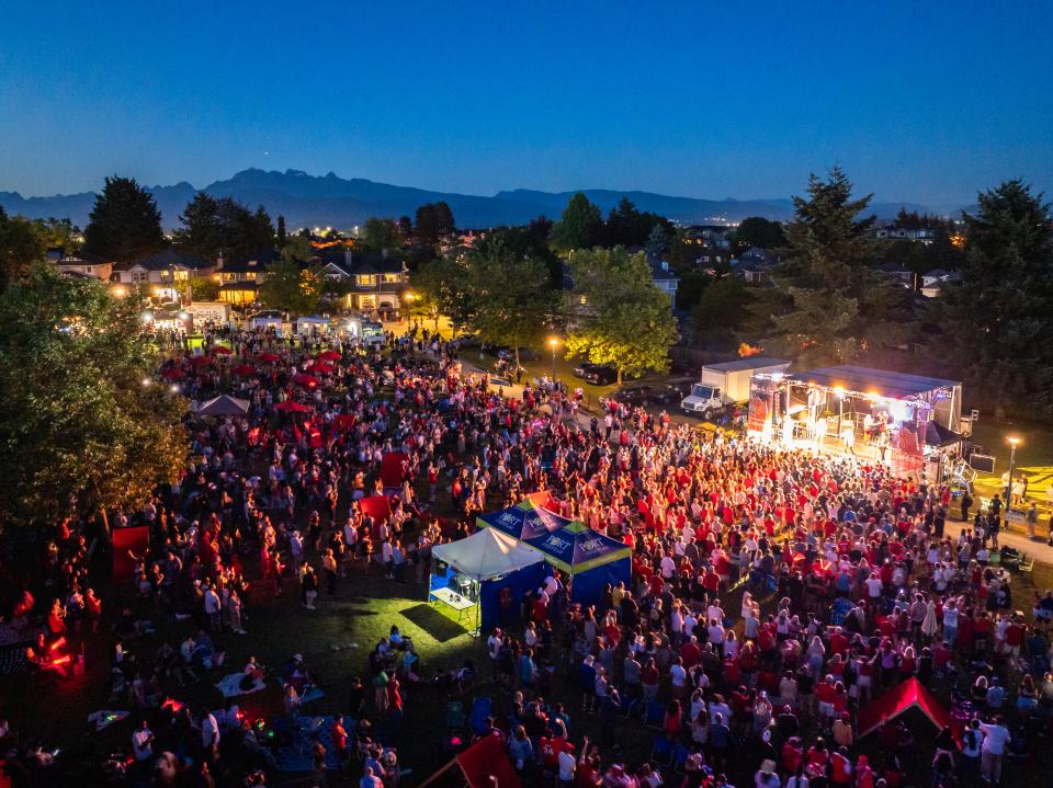 aerial view of crowd in front of stage at Canada Day celebration in the park